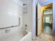 Tiled shower is next to an open door leading to the bedroom with marble floors at 2055 S Floral Ave # 291, Bartow, FL 33830