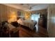 Bedroom featuring wood floors, side table, TV and large bed at 2055 S Floral Ave # 45, Bartow, FL 33830