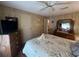 Bedroom featuring wood floors, large bed and large television at 2055 S Floral Ave # 45, Bartow, FL 33830