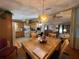 Dining room with wood table and adjacent living room, offering space for entertaining and everyday living at 2055 S Floral Ave # 45, Bartow, FL 33830