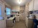 Laundry room with counter, white cabinets and floral wallpaper at 2055 S Floral Ave # 45, Bartow, FL 33830