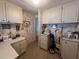 Bright laundry room with floral wallpaper, white cabinets and countertop at 2055 S Floral Ave # 45, Bartow, FL 33830
