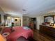 Bright main bedroom featuring wood floors, ceiling fan and ensuite bathroom at 2055 S Floral Ave # 45, Bartow, FL 33830