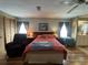 Comfortable main bedroom features wood laminate flooring and an ensuite bathroom at 2055 S Floral Ave # 45, Bartow, FL 33830