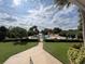 Inviting community pool area with lush landscaping, lounge chairs, and a charming pool house at 2055 S Floral Ave # 45, Bartow, FL 33830