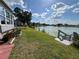Lush backyard with manicured lawn leads to a tranquil lake at 2055 S Floral Ave # 69, Bartow, FL 33830