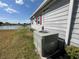 Exterior view showing the home's AC unit with the lake in the background at 2055 S Floral Ave # 69, Bartow, FL 33830
