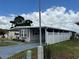 Charming single story home with a covered driveway and a well-maintained white picket fence at 2055 S Floral Ave # 69, Bartow, FL 33830
