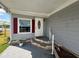Cozy front porch with brick-lined steps and red shutters, creating a welcoming entrance at 2055 S Floral Ave # 69, Bartow, FL 33830