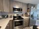 Contemporary kitchen featuring stainless steel appliances, sleek countertops, and wood cabinets at 2055 S Floral Ave # 69, Bartow, FL 33830