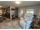 Inviting living room featuring a recliner, complemented by a view of the kitchen at 2055 S Floral Ave # 69, Bartow, FL 33830