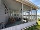 Screened in patio with lake views and relaxing outdoor furniture at 2055 S Floral Ave # 69, Bartow, FL 33830