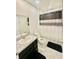 Bathroom featuring neutral tile floors, neutral granite, and a dark vanity at 264 Fiddlewood Ct, Davenport, FL 33837