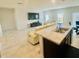 Open-concept living room featuring tile floors and abundant natural light from the windows at 264 Fiddlewood Ct, Davenport, FL 33837