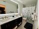 Modern bathroom with double sinks, marble counters, and stylish fixtures at 2742 Pine Acres Dr, Lake Wales, FL 33898