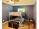 A simply furnished bedroom with a bunk bed, wooden floors, and minimal decor at 2742 Pine Acres Dr, Lake Wales, FL 33898