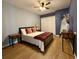 Cozy bedroom featuring wood floors, closet doors, and stylish decor at 2742 Pine Acres Dr, Lake Wales, FL 33898