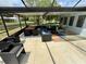 Inviting screened outdoor living space with dining and seating areas, perfect for enjoying meals and relaxation by the water at 2742 Pine Acres Dr, Lake Wales, FL 33898