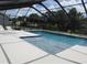 Inviting screened pool with attached spa and ample deck space, perfect for outdoor entertaining and enjoying the sun at 2742 Pine Acres Dr, Lake Wales, FL 33898