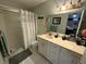Well-lit bathroom featuring a vanity with ample counter space, a large mirror, and a glass-enclosed shower at 294 Winter Ridge Blvd # 294, Winter Haven, FL 33881