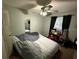 Bedroom featuring a ceiling fan, dark curtains, and a full length mirror at 294 Winter Ridge Blvd # 294, Winter Haven, FL 33881
