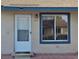 Inviting home featuring a front door, a window with blue trim, and the house number is prominently displayed at 294 Winter Ridge Blvd # 294, Winter Haven, FL 33881