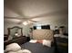 Spacious main bedroom featuring a tufted headboard, a ceiling fan, and coordinating decor at 294 Winter Ridge Blvd # 294, Winter Haven, FL 33881