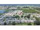 Aerial view of a home with a red arrow pointing to it in a neighborhood near a lake at 3154 Prairie Dunes W Cir, Lakeland, FL 33810