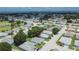 Aerial view of a charming neighborhood with well-maintained lawns near a pond at 3154 Prairie Dunes W Cir, Lakeland, FL 33810