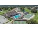 Community clubhouse boasts a swimming pool, tennis and shuffleboard courts and a golf course in this aerial view at 3154 Prairie Dunes W Cir, Lakeland, FL 33810