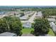 An aerial view of a residential area with houses and trees on a clear day at 3154 Prairie Dunes W Cir, Lakeland, FL 33810