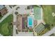 Aerial shot showcases the clubhouse, pool, tennis court and parking area, bordered by a lush golf course at 3154 Prairie Dunes W Cir, Lakeland, FL 33810
