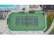Aerial view of the tennis court surrounded by landscaping and fencing at 3154 Prairie Dunes W Cir, Lakeland, FL 33810