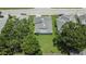 Overhead view of a well-maintained home featuring green lawns and mature trees at 3154 Prairie Dunes W Cir, Lakeland, FL 33810