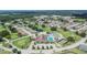 Aerial view shows the clubhouse, golf course, tennis court and swimming pool in a vibrant 55+ community at 3154 Prairie Dunes W Cir, Lakeland, FL 33810