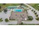 Aerial view showcases the community clubhouse, pool, tennis court, and golf course at 3154 Prairie Dunes W Cir, Lakeland, FL 33810