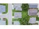 An aerial view of a neighborhood with houses and tree-lined streets on a sunny day at 3154 Prairie Dunes W Cir, Lakeland, FL 33810