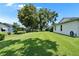 Picture showing the backyard of a home with manicured lawn and large trees providing shade at 3154 Prairie Dunes W Cir, Lakeland, FL 33810