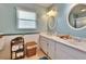 Bright bathroom featuring a double vanity, wicker storage, and classic fixtures at 3154 Prairie Dunes W Cir, Lakeland, FL 33810