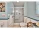 Clean bathroom featuring a glass enclosed shower, a toilet, and wainscotting at 3154 Prairie Dunes W Cir, Lakeland, FL 33810
