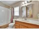 Well-lit bathroom featuring a vanity with drawers and cabinets, a mirror, and a shower with a curtain at 3154 Prairie Dunes W Cir, Lakeland, FL 33810
