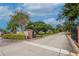 Gated entrance to the community featuring well-maintained landscaping and mature trees at 3154 Prairie Dunes W Cir, Lakeland, FL 33810