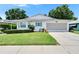 Charming single-story home boasts a well-manicured lawn and blue shutters at 3154 Prairie Dunes W Cir, Lakeland, FL 33810