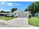 Well-maintained single-story home with a spacious driveway and attached garage at 3154 Prairie Dunes W Cir, Lakeland, FL 33810