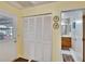 Hallway featuring a closet with folding doors and a view of the bathroom at 3154 Prairie Dunes W Cir, Lakeland, FL 33810