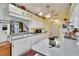 White kitchen with countertops, appliances, a fish tank, and a view to the bathroom at 3154 Prairie Dunes W Cir, Lakeland, FL 33810