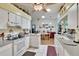 Bright kitchen features white cabinetry, an island, and plenty of countertop space at 3154 Prairie Dunes W Cir, Lakeland, FL 33810