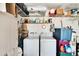 Laundry room features white washer and dryer and lots of storage space at 3154 Prairie Dunes W Cir, Lakeland, FL 33810