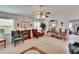 Cozy living room with a fireplace, soft carpet, and natural light from the window at 3154 Prairie Dunes W Cir, Lakeland, FL 33810