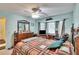 Relaxing primary bedroom with a ceiling fan and a bay window overlooking the property at 3154 Prairie Dunes W Cir, Lakeland, FL 33810